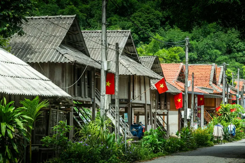 Wooden stilt houses along a village lane in Mai Chau