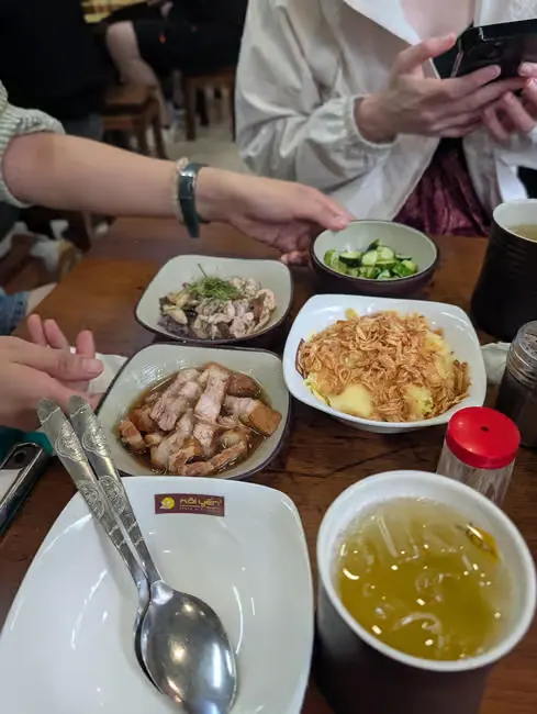 A table of Vietnamese dishes shared on the Hanoi street food tour